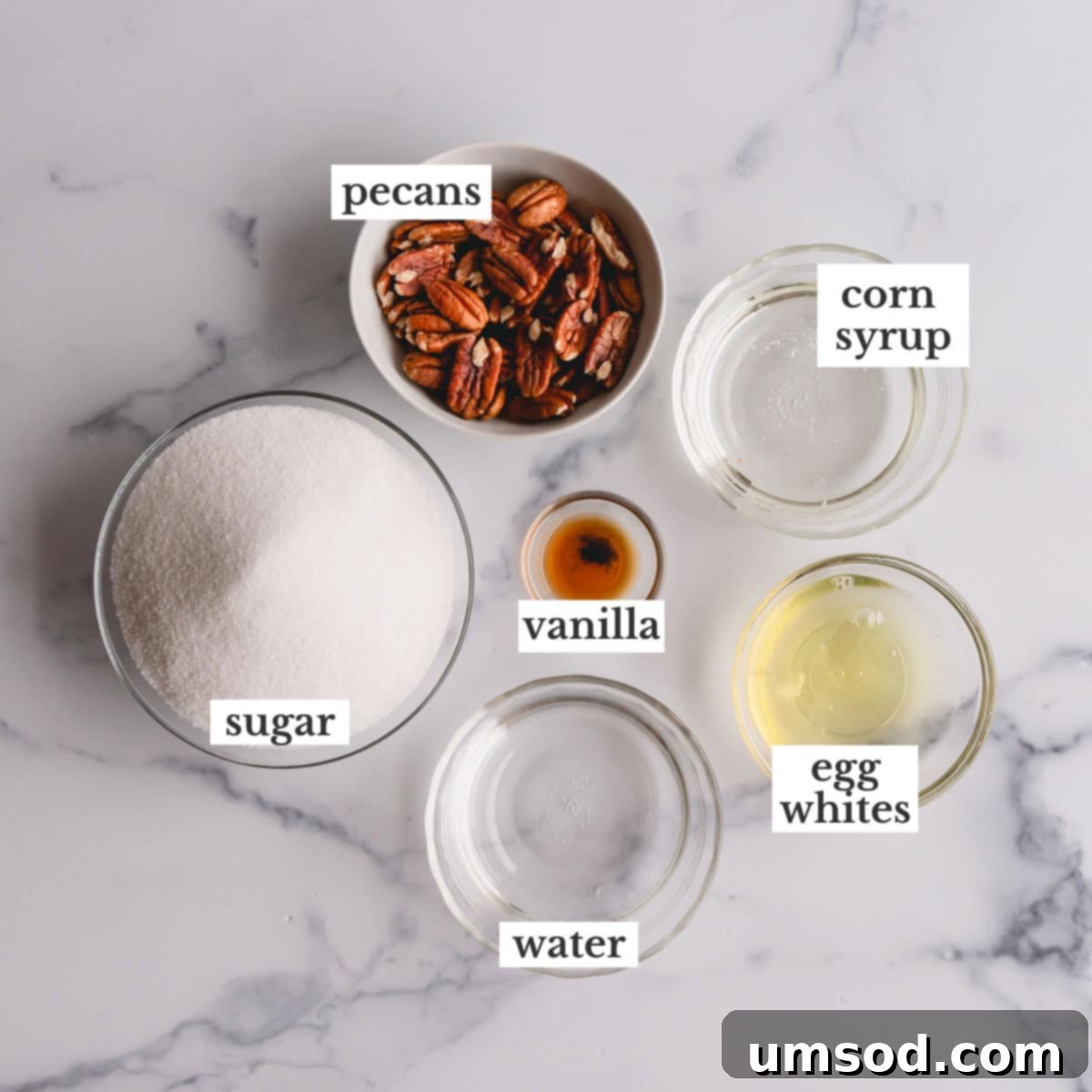Close-up photo of the essential ingredients laid out for making divinity candy, including sugar, corn syrup, egg whites, and vanilla extract.