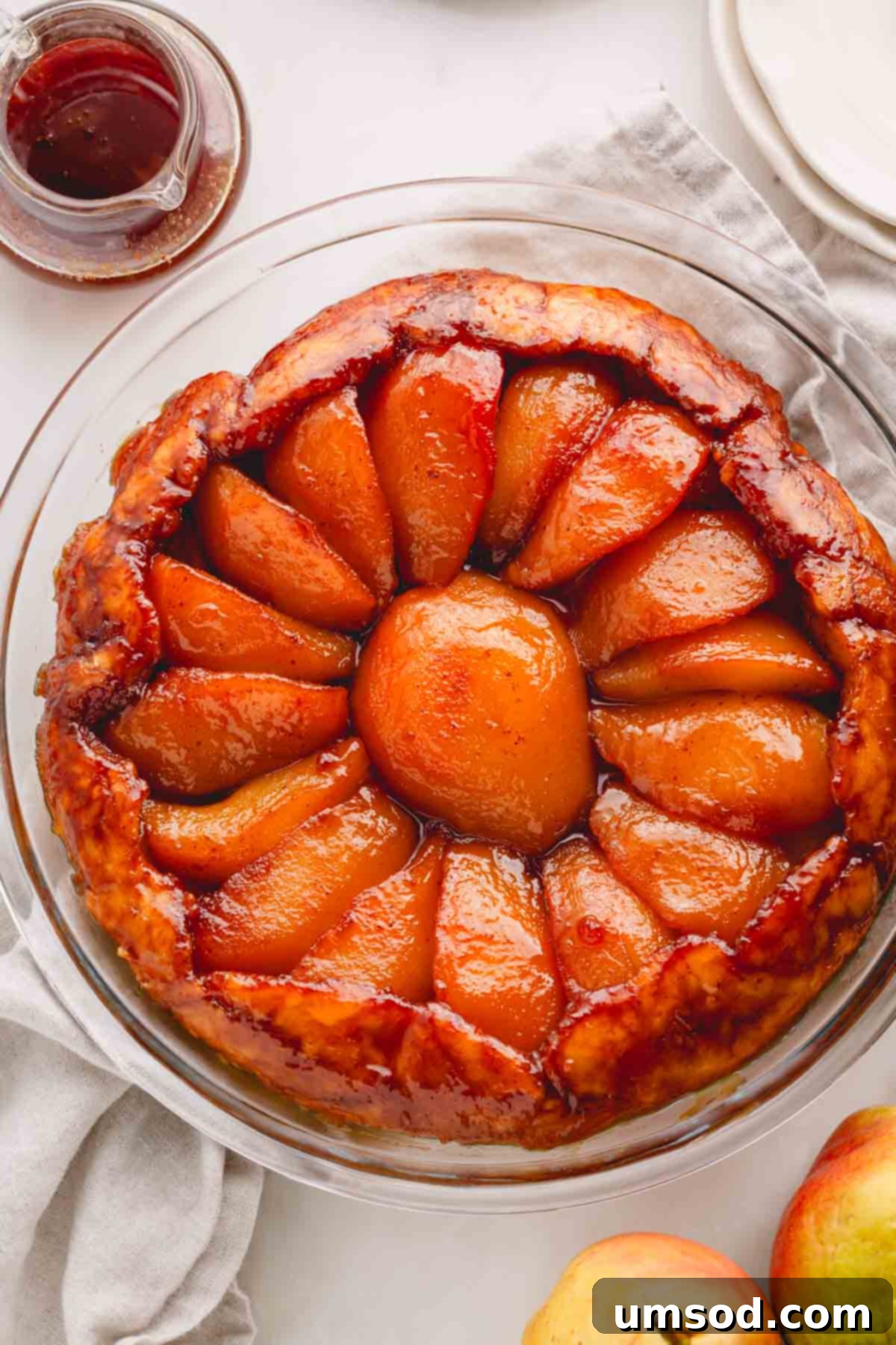 Golden Caramel Pear Tart 2 Overhead image of a pear tarte tatin in a glass baking dish, beautifully golden and inviting.