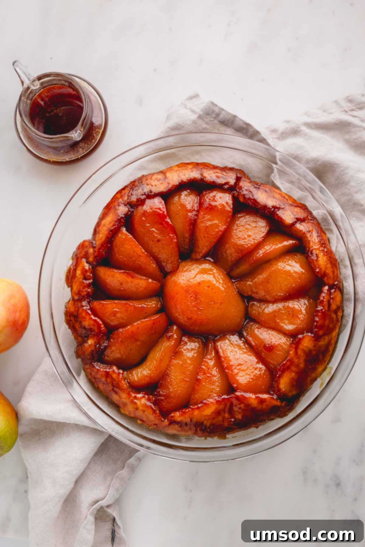 Golden Caramel Pear Tart 11 Overhead image of a pear tarte tatin, showcasing its golden crust and caramelized fruit.