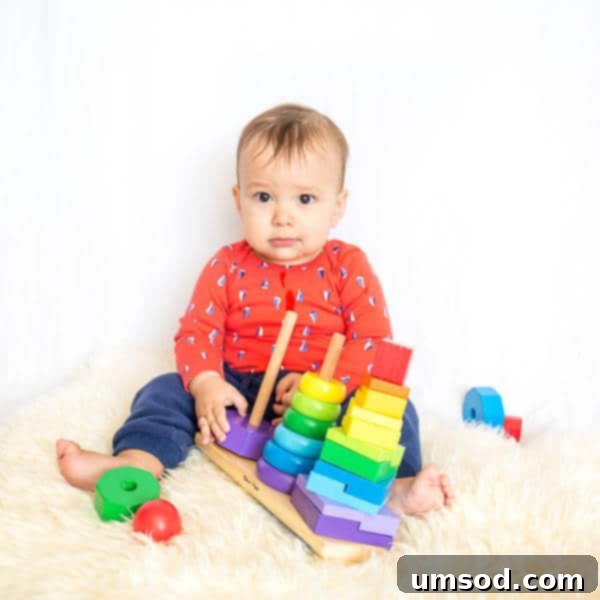 Baby Grant at 10 and 11 Months 6 Grant sitting on the floor, happily playing with colorful toys, immersed in his own world.