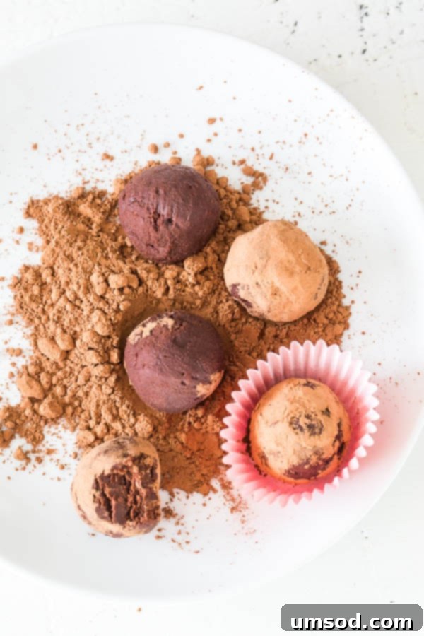 Sinfully Simple Spiked Truffles 3 A close-up shot of an irresistible 2-Ingredient Red Wine Truffle, showcasing its rich texture and cocoa powder coating.