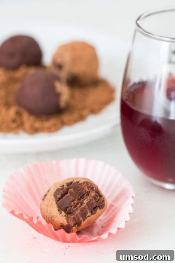 Sinfully Simple Spiked Truffles 5 A beautifully presented Red Wine Truffle, perfectly rolled and ready to be enjoyed, highlighting its simple elegance.