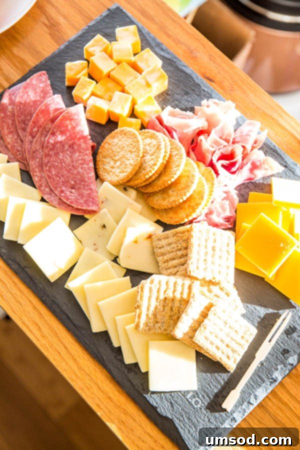 Mini cheese board and brown gravy meatballs with mashed potatoes