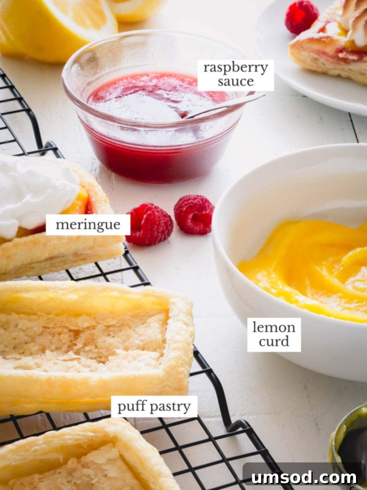 A bowl of seedless raspberry sauce, meringue, cooked puff pastry tart shells and a bowl of lemon curd.