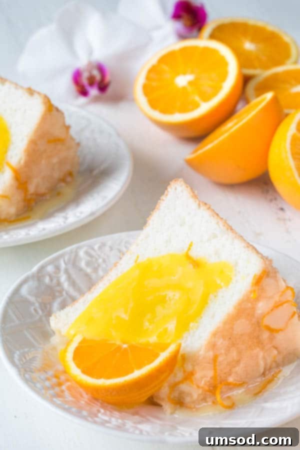 Infused with citrusy floral orange blossom, this angel food cake is simply the BEST! And you sure don't want to omit that orange curd, it takes this cake from great to FABULOUS!