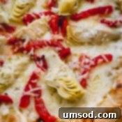 A whole grilled artichoke pizza.