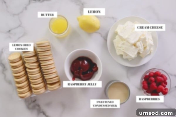 A selection of key ingredients for the lemon raspberry cheesecake, including cream cheese, lemons, raspberries, and Oreos.