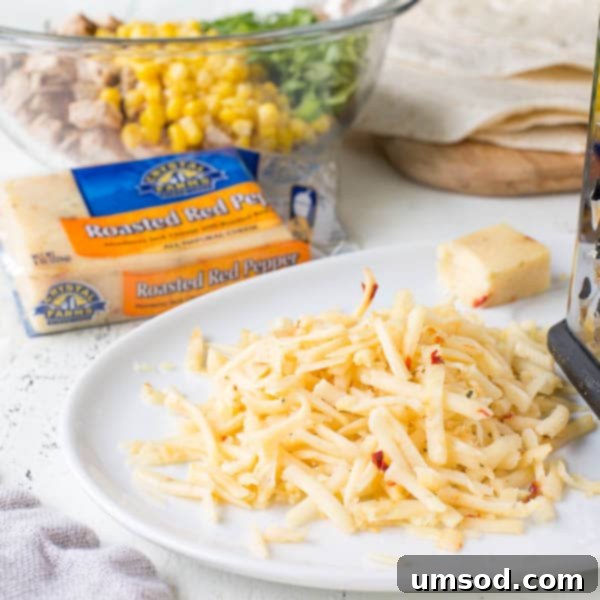 Effortless 30-Minute Cheesy Chicken Quesadillas 4 A close-up shot of a cheesy chicken quesadilla showing the golden-brown tortilla and the rich, bubbling Crystal Farms Roasted Red Pepper Cheese inside.