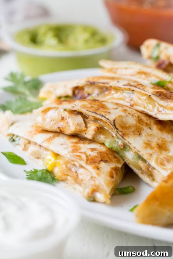 Effortless 30-Minute Cheesy Chicken Quesadillas 7 A beautiful stack of freshly made, golden-brown cheesy chicken quesadillas, expertly cut into perfect wedges, ready to be served and enjoyed as a quick and easy weeknight meal.
