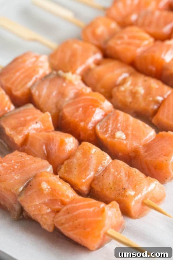 Sticky Honey Sesame Salmon Skewers 3 Cooked honey sesame salmon kebabs arranged neatly on a baking sheet, ready to serve.