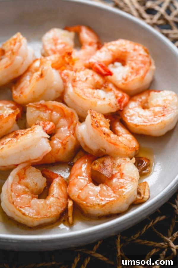 Garlic Butter Shrimp 3 Delicious garlic butter shrimp arranged beautifully on a plate, highlighting their plump and pink texture, garnished with fresh parsley.