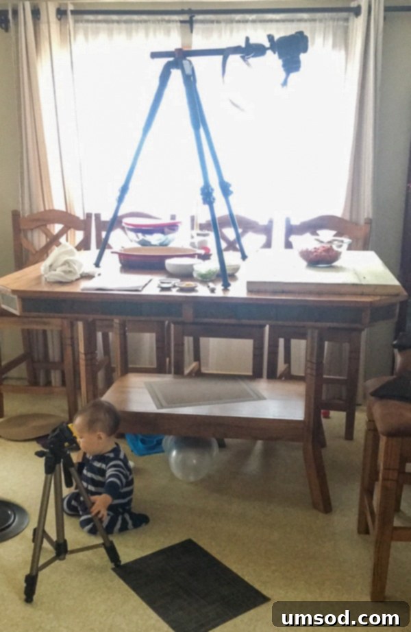 Young Grant sitting in a high chair, watching intently as his mom prepares food.