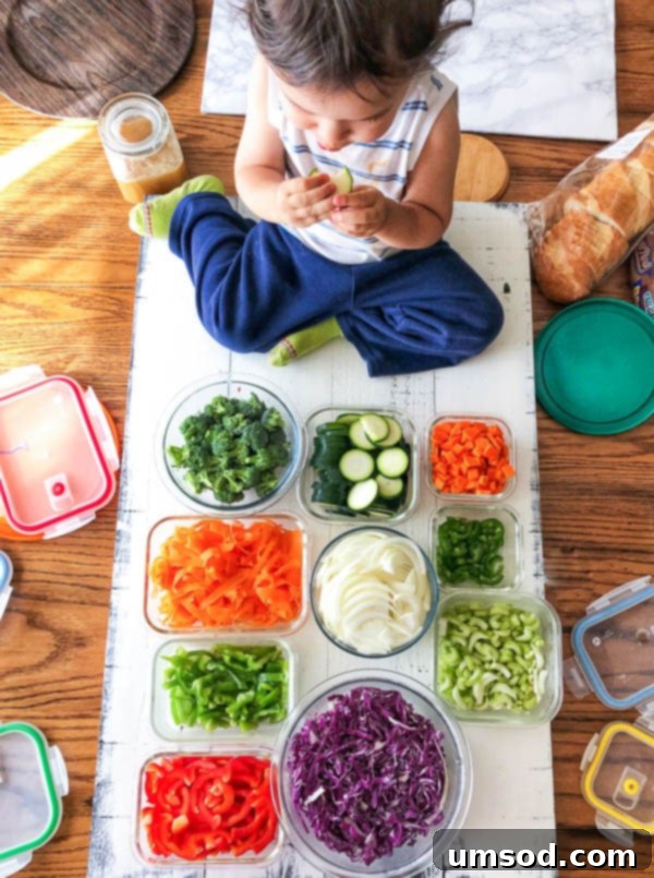Toddler Grant snacking on raw vegetables while his mom works on food preparation.