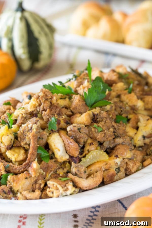A platter of golden brown Instant Pot sausage stuffing topped with fresh parsley, ready to serve.
