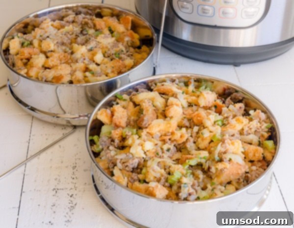 Two Instant Pot steamer pans filled with uncooked sausage stuffing, stacked and ready to be placed inside the Instant Pot.