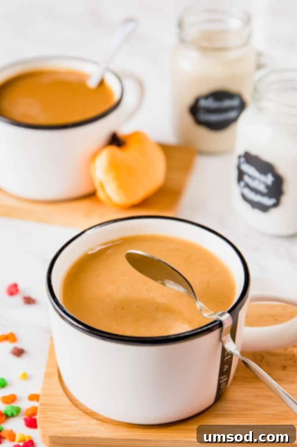 Sweet Crust Coffee 7 A steaming mug of dairy-free pumpkin spice coffee, with dairy-free creamers and a bag of Dunkin' Donuts Pumpkin Spice coffee in the background.