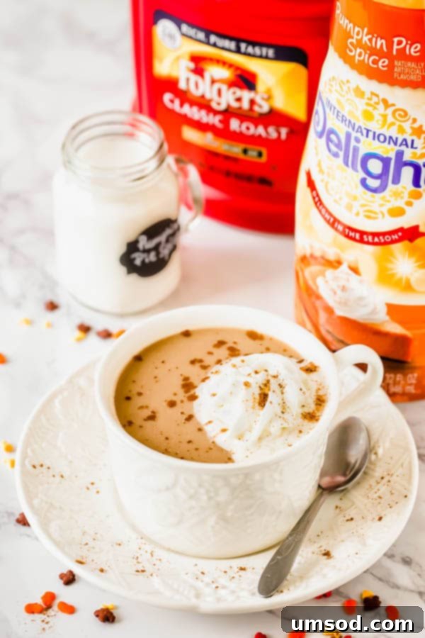 Sweet Crust Coffee 8 A cup of pumpkin pie spice coffee next to a bottle of International Delight Pumpkin Pie Spice creamer.