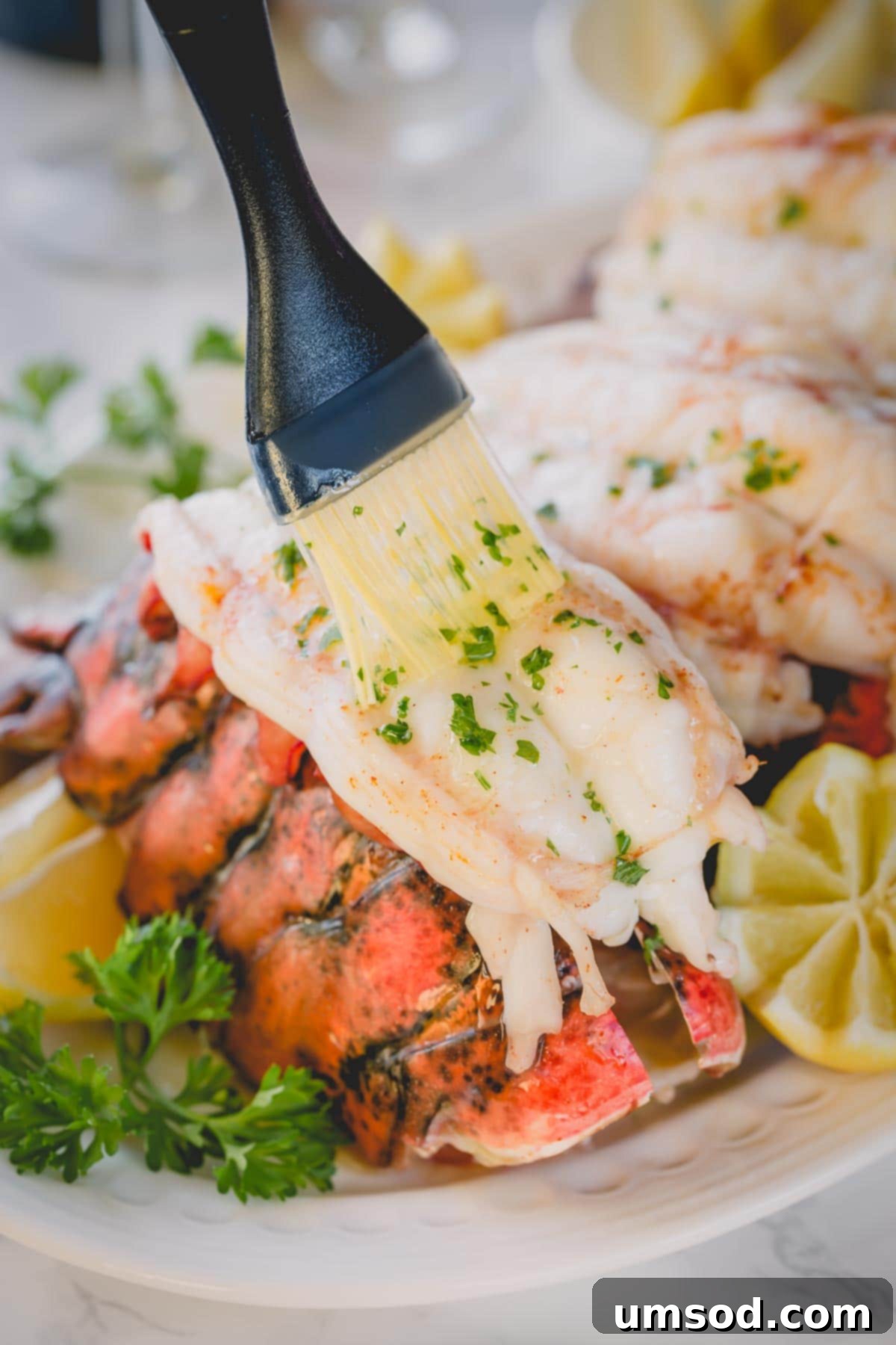 Brushing baked lobster meat with melted butter.