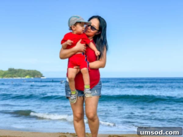 Tropical plants and flowers framing a distant ocean view in Kauai