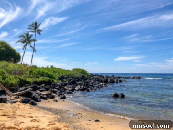 Beautiful sandy beach on Kauai's South Shore with gentle waves