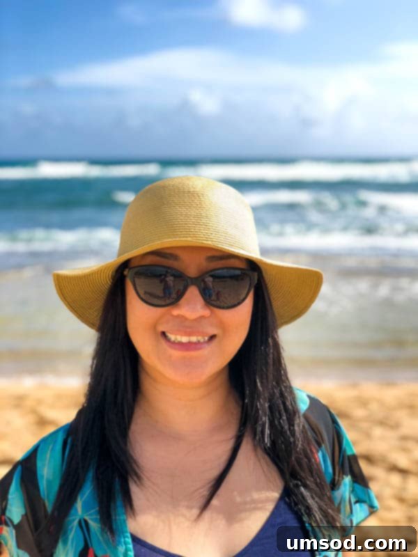 Close-up of tropical foliage with water droplets, showcasing Kauai's lushness