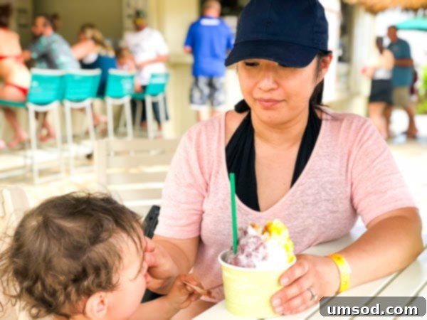 Toddler enjoying a swim in the resort pool in Kauai