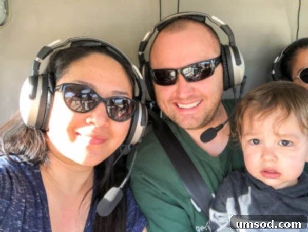 Toddler Grant with parents inside a helicopter, looking out at the Kauai landscape