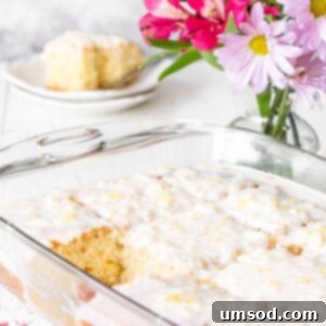 A baking dish of pineapple cake with a square missing, ready to be enjoyed.