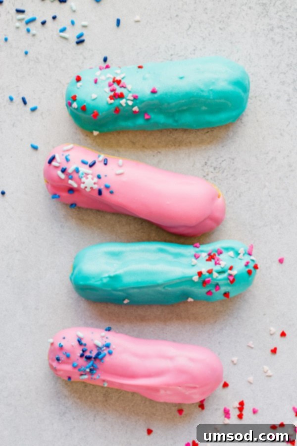 Pink or Blue Eclair Mystery 2 Beautifully decorated gender reveal eclairs with pink and blue sprinkles, ready to reveal the baby's gender.