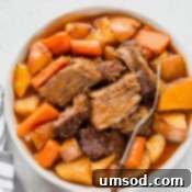 A beautifully presented pot roast, ready to be enjoyed, with rich gravy and rustic sides, symbolizing hearty comfort food.