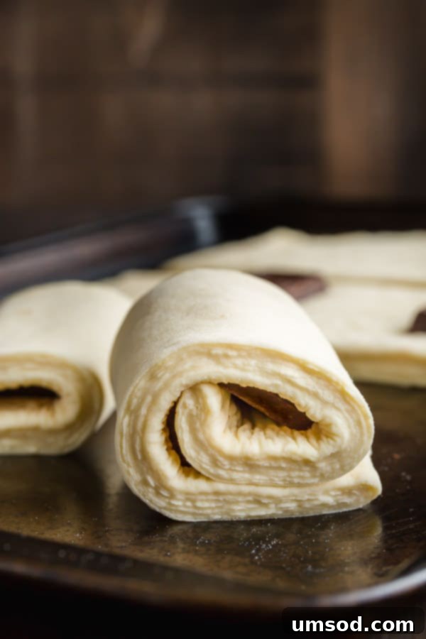 Flaky Chocolate Indulgence 7 Croissant dough wrapped around chocolate bar, ready to be proofed before baking.
