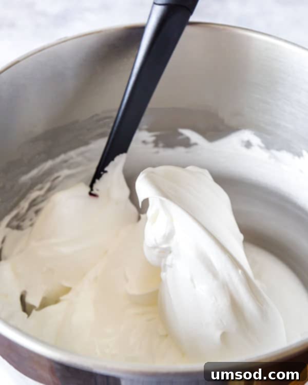 Luscious Strawberry Pavlova Bites 4 The perfectly whipped meringue batter for Pavlova cake, demonstrating stiff peaks and a glossy texture, ready for shaping.