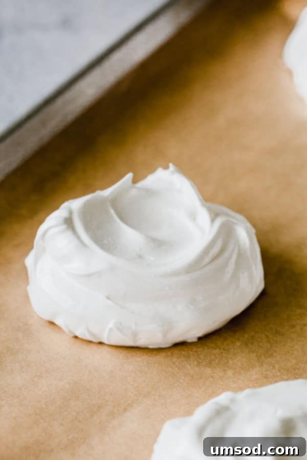 Luscious Strawberry Pavlova Bites 5 Eight perfectly formed Pavlova meringue bases, with central wells, arranged neatly on a baking sheet, awaiting the oven.