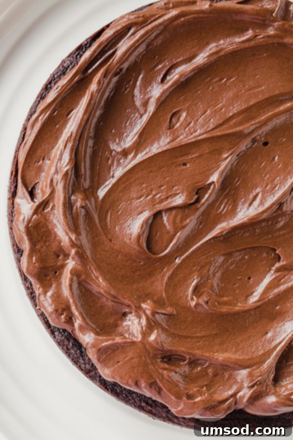 Detailed step-by-step preparation for homemade mocha frosting, showing a bowl with bittersweet chocolate, butter, and instant espresso powder, ready for the warm cream. Perfect for baking enthusiasts.
