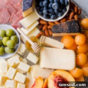 Summer Cheese Board, featuring an array of fruits, cheeses, and charcuterie.