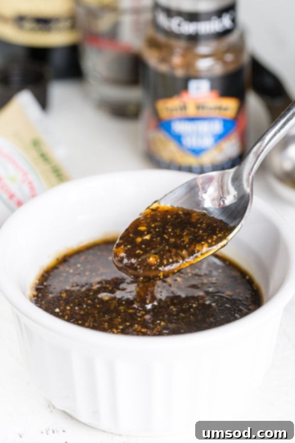Ultimate Prime Rib Perfection 3 A close-up shot of the prime rib marinade in a bowl, with a spoon lifting a scoop to show its rich texture.