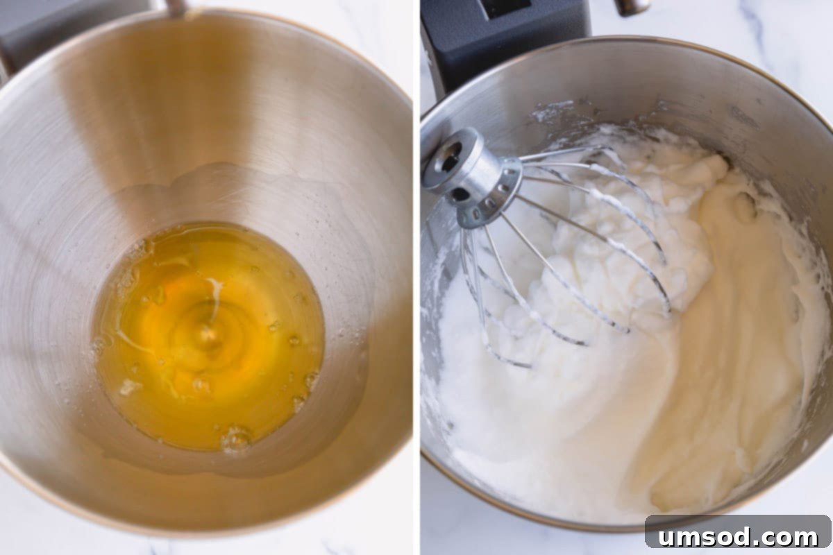 Egg whites being whipped to soft, glossy peaks in a stand mixer, demonstrating proper meringue consistency.