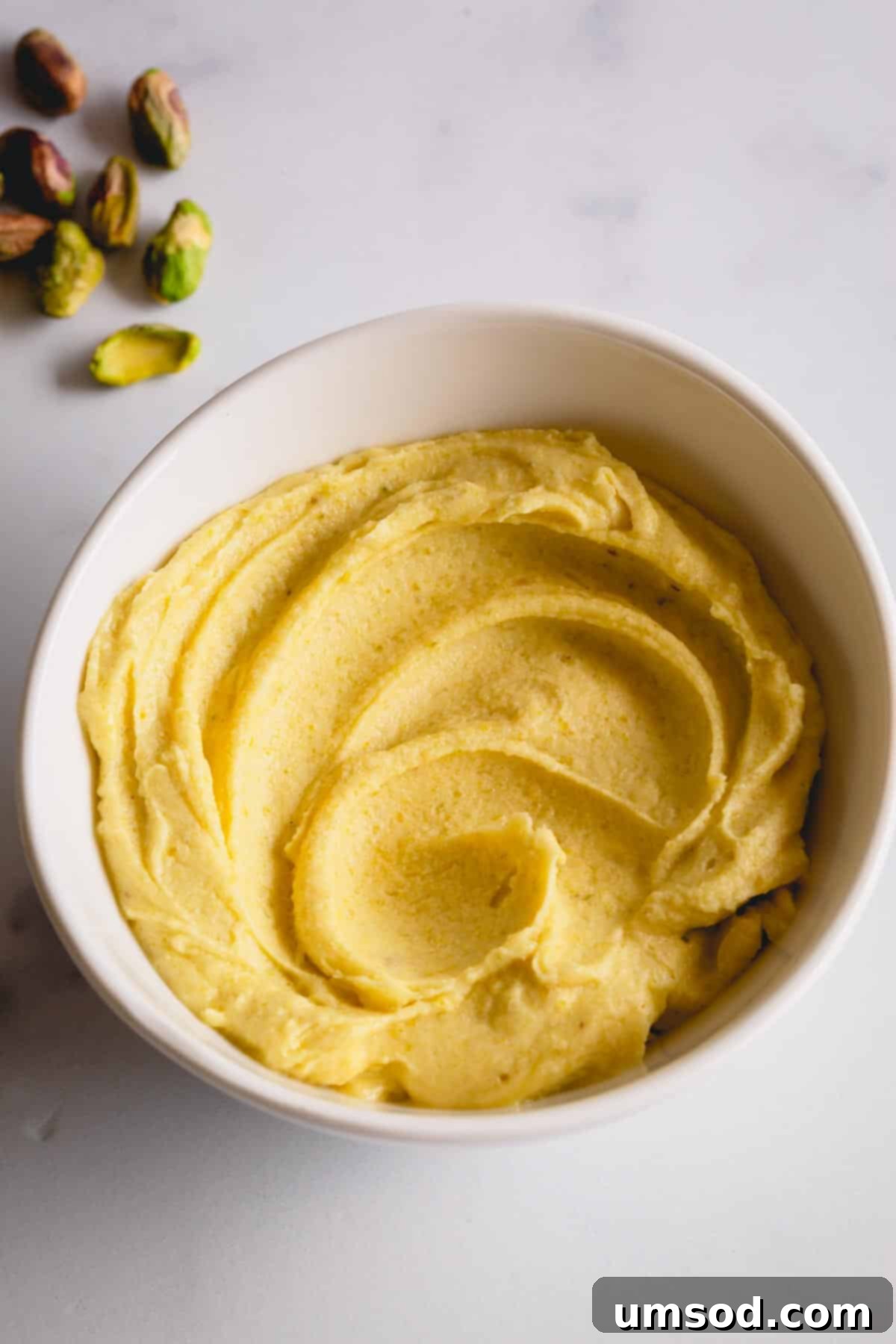 Velvety Pistachio French Buttercream Filling 5 A beautiful bowl filled with the finished, vibrant green pistachio cream filling, ready to be used.