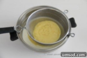 Crushing Oreo cookies into small pieces, preparing them to be folded into the ice cream.