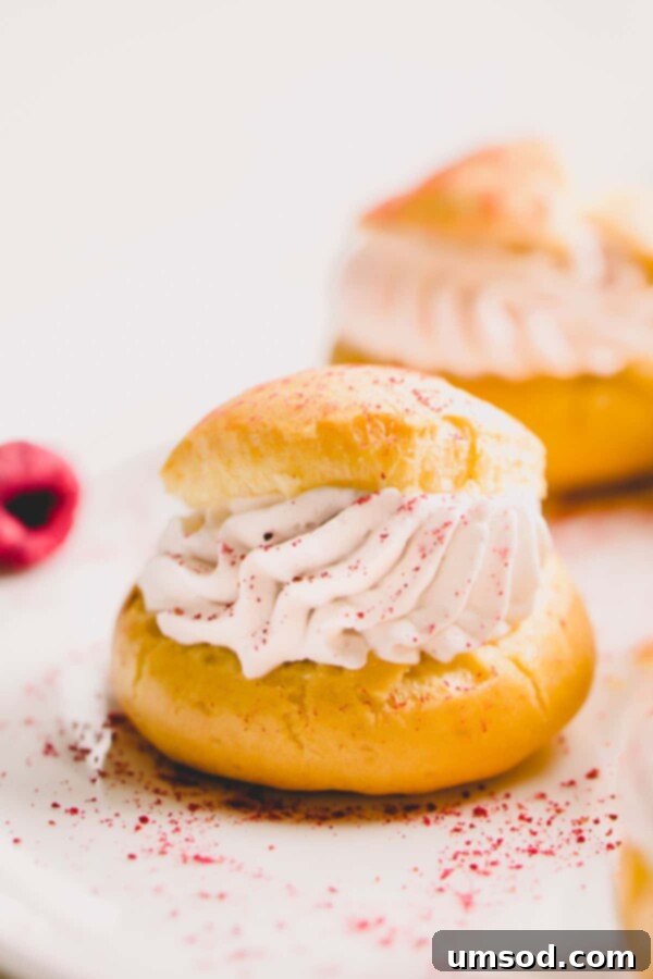 Close-up of baked choux pastry shells showing their hollow interior and crisp texture.