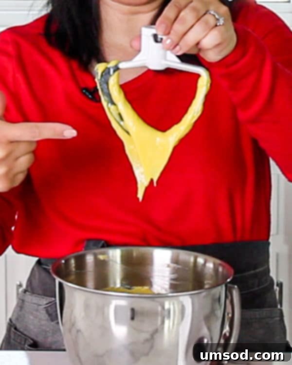 Choux pastry batter demonstrating the perfect 'V' shape consistency on a spatula.