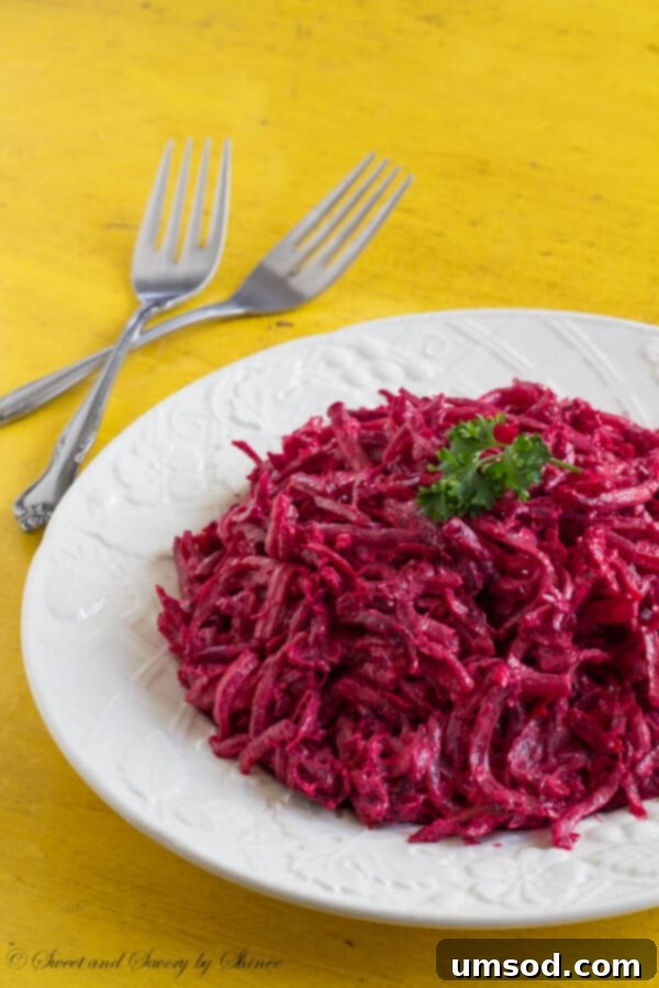 A vibrant bowl of creamy roasted beet salad, showcasing its rich purple hue and smooth texture, ready to be served.