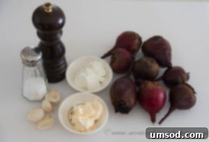 Ingredients laid out for creamy beet salad: whole beets, sour cream, mayonnaise, and garlic cloves.