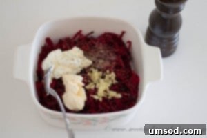Step-by-step image of combining grated beets with sour cream, mayonnaise, and roasted garlic.