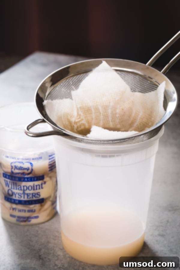 Hearty Oyster Potato Stew 3 A jar of premium jarred oysters, ready for use in the stew. The liquid is clear, and the oysters are plump and healthy-looking, ensuring a great start to the dish.