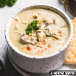 Hearty Oyster Potato Stew 6 A close-up shot of a warm bowl of creamy oyster stew, ready to be served, highlighting its rich texture and inviting aroma.