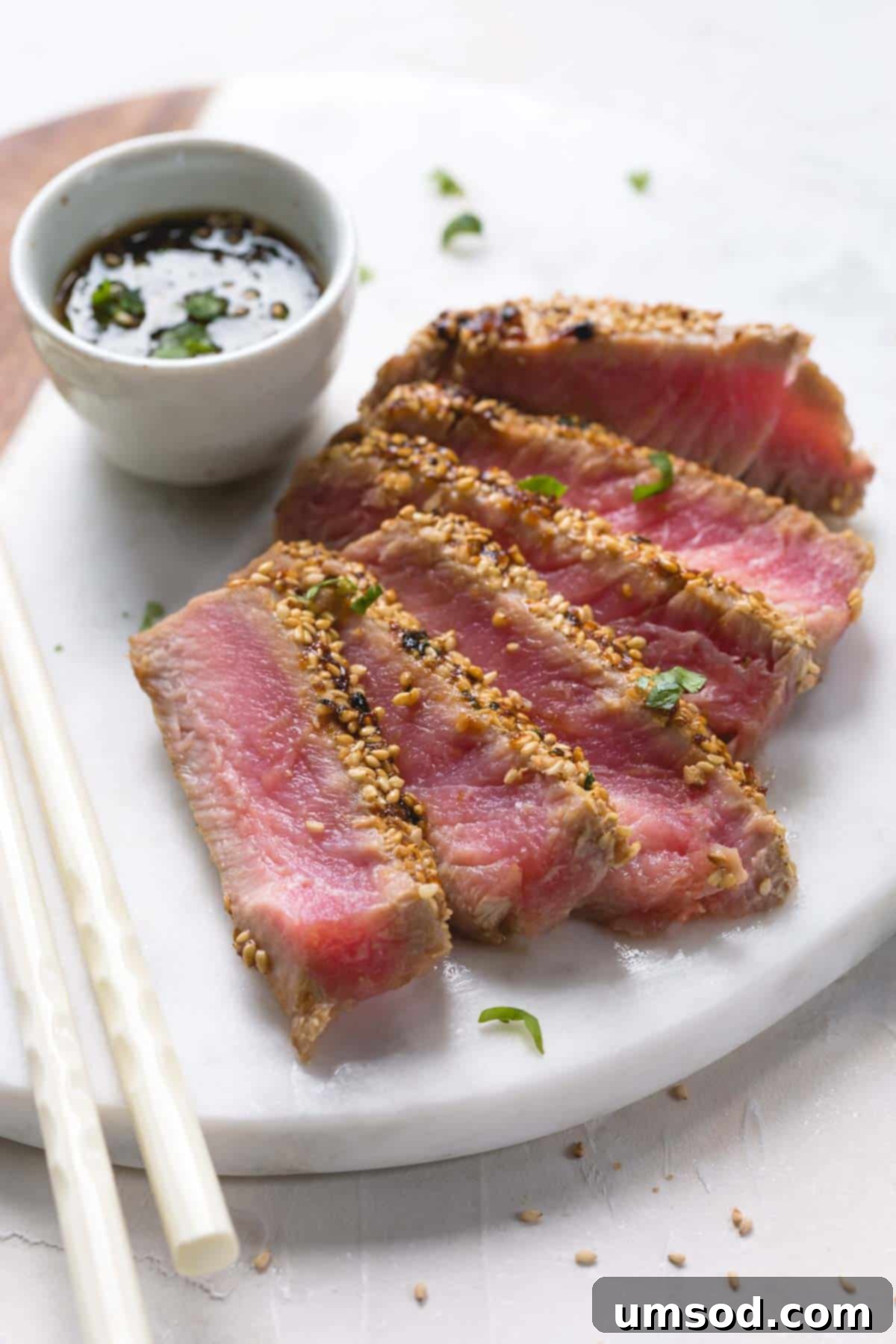 Sesame-Crusted Ahi Tuna 2 Seared and sliced ahi tuna with sesame crust on a platter.