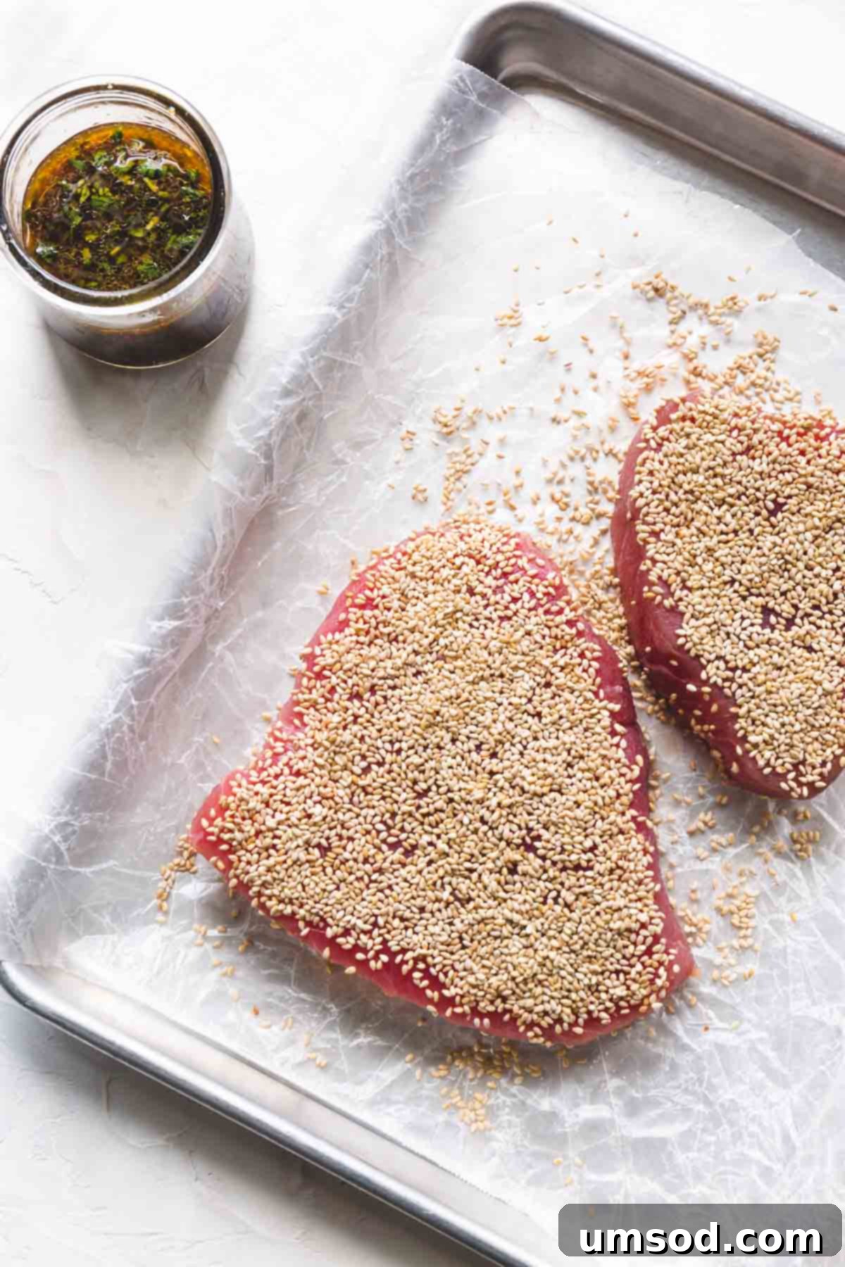 Sesame-Crusted Ahi Tuna 4 Raw ahi tuna steaks covered with sesame seeds.