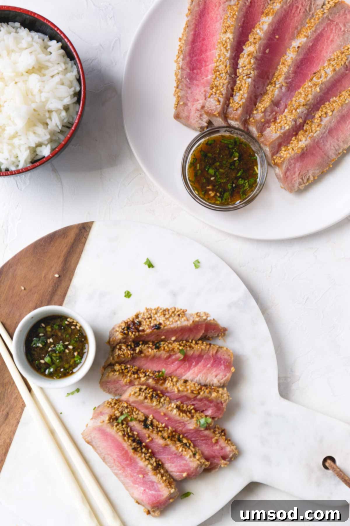 Sesame-Crusted Ahi Tuna 7 Sliced ahi tuna steak with sesame crust on a platter with dipping sauce on a side.