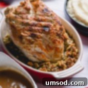 A smaller image of stuffing with a roasted turkey breast on top, mirroring the main recipe image.